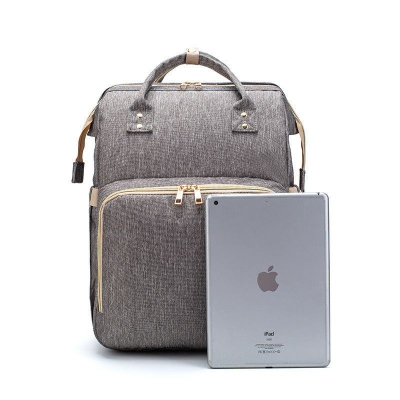 Portable Baby Haven: Diaper Bag Backpack with Built-In Bed & Charging Port!
